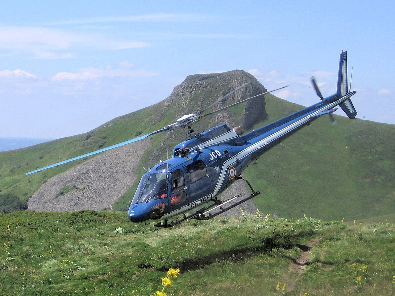 Mountain rescue helicopter flying over hills — emergency evacuation support