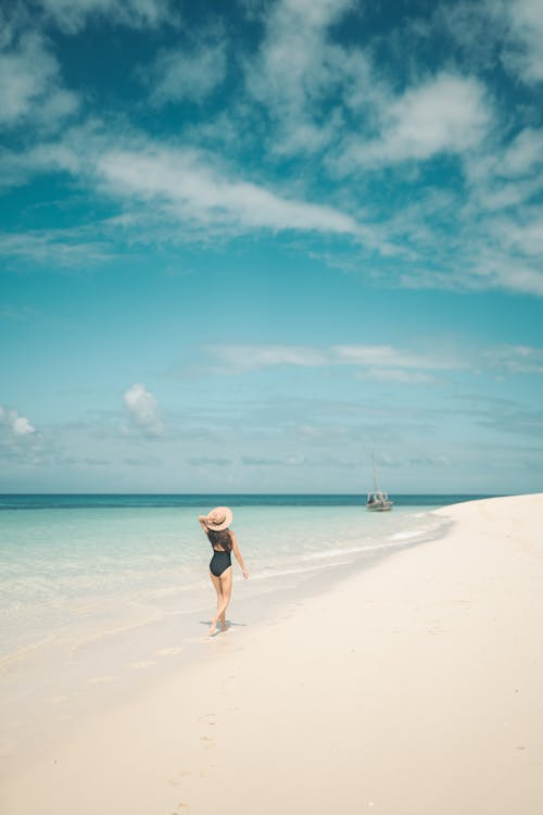 Stroll along white sand at the shoreline, turquoise sea and sky